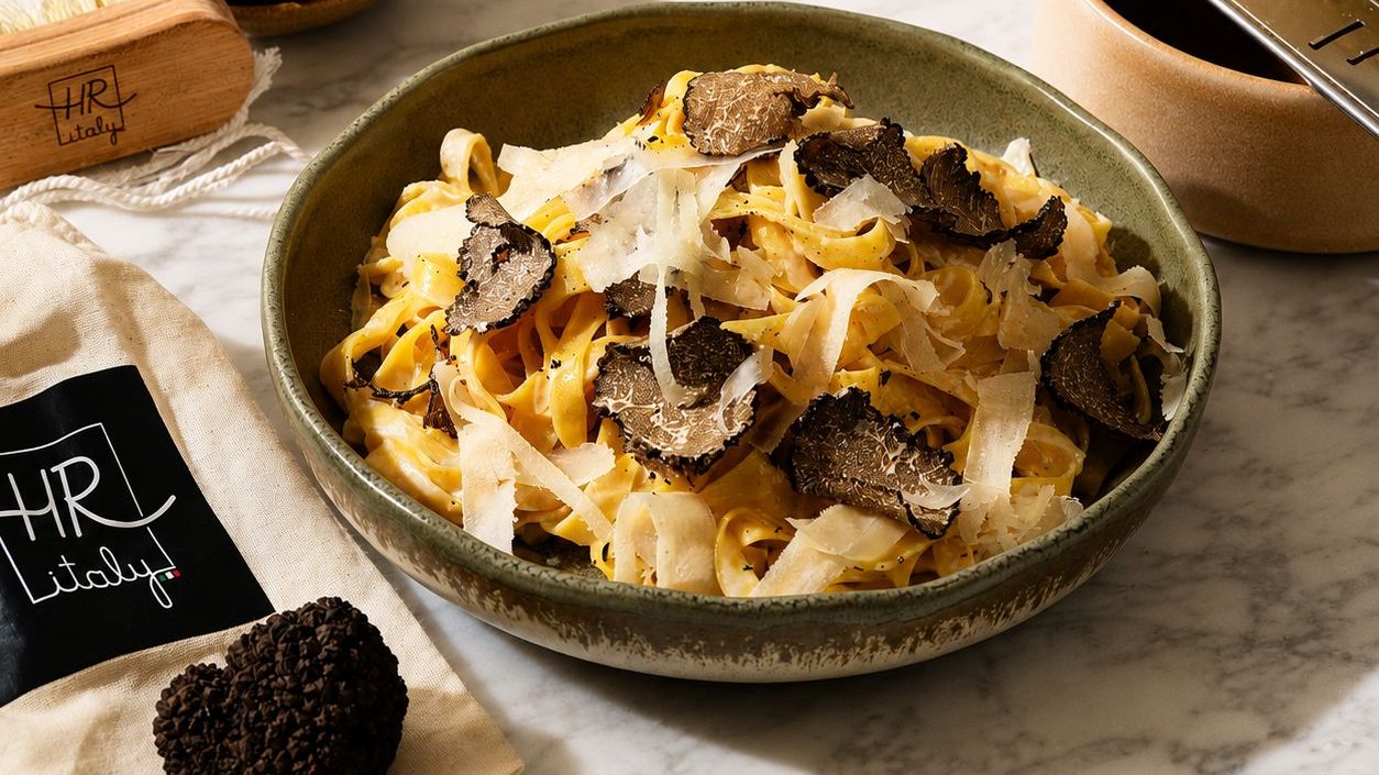 HR Italy truffle fettuccine with shaved black truffle and Parmesan, whole truffles on the side